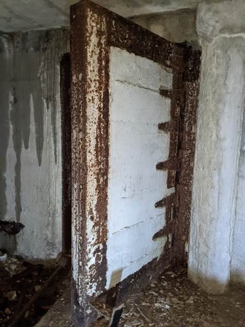 A picture containing building, dirty, old, door

Description automatically generated